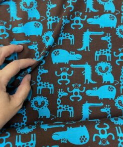 Baumwolljersey Zootiere in petrol auf dunkelbraun